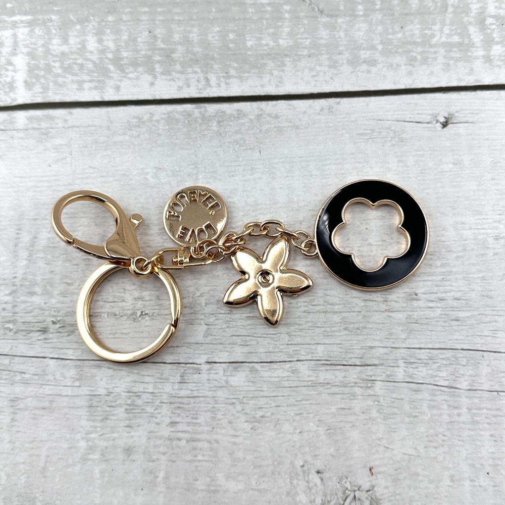 Unbranded keychain or purse charm. Gold and black. NEW.